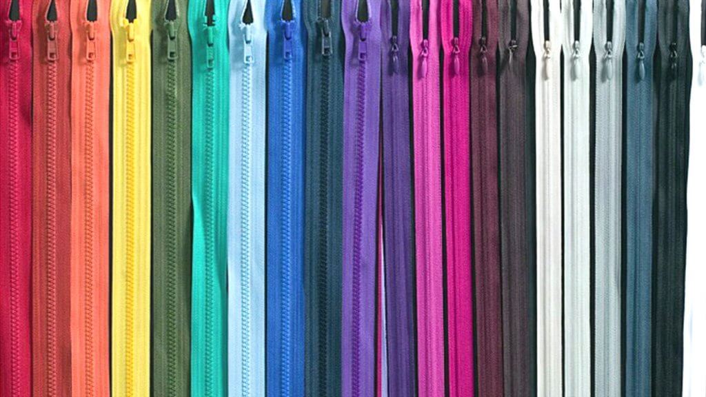 picture of zippers lined up side by side, all different colors